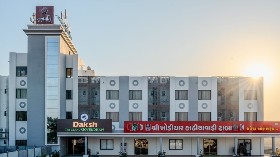 Front view of Daksh The Grand Gowardhan, Dwarka, bathed in the soft glow of sunrise, showcasing its modern architecture.