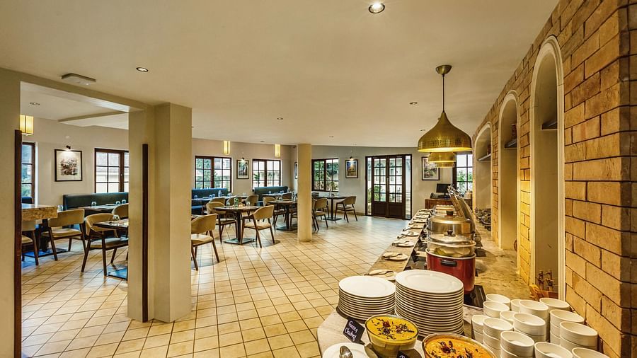 Comprehensive breakfast spread at Mango Hill Shola, Ooty featuring South Indian and continental options in a bright, modern setting.