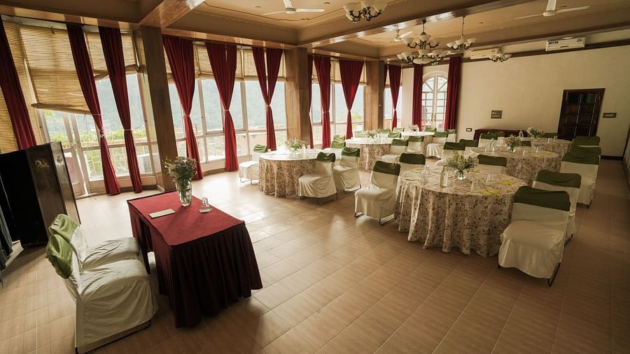 A room with tables and chairs, possibly a dining area or event space.