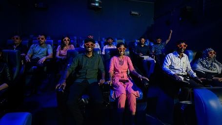 Guests immersed in an exciting 4D cinema experience at MGM Dizzee World, seated in motion-enabled chairs with special effects enhancing the film.