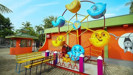 A bright and playful photo zone at MGM Dizzee World decorated with large emoji cutouts and fun props, ideal for selfies and group pictures.