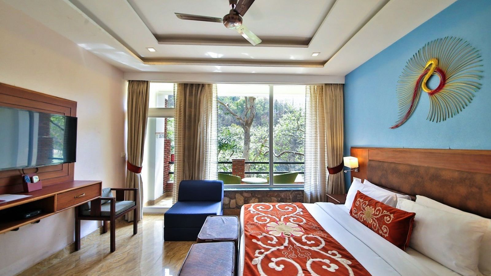 Premium Room witt seating area, bed and a televisoon i front of it at Summit By The Ganges Beach Resort & Spa, Rishikesh