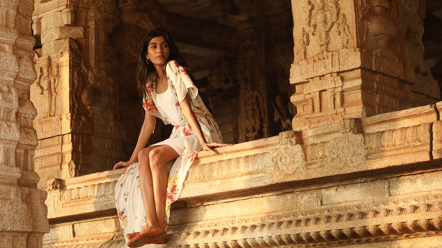 Guest exploring ancient carved temple ruins near Evolve Back Hampi