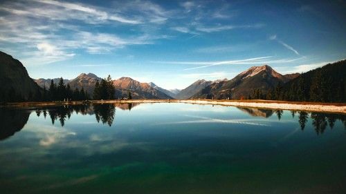 An image of a lake with mountains in the background