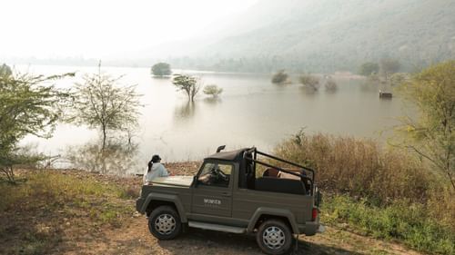 duplicate of a jeep besides a lake near Ananta Spa and Resort, Ajabgarh