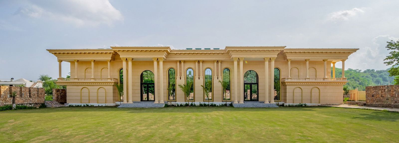 Facade of The Royal Know Banquet Hall at Valley by Grassfield, featuring large windows and a spacious open area in front.