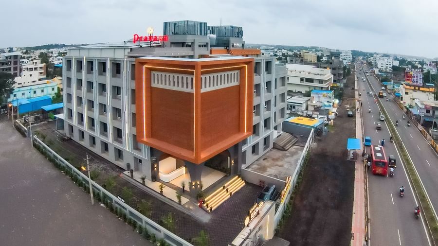 Building exterior of Pravasa Hotel from a distance with surrounding roads | Pravasa Hotel, Vijayapura