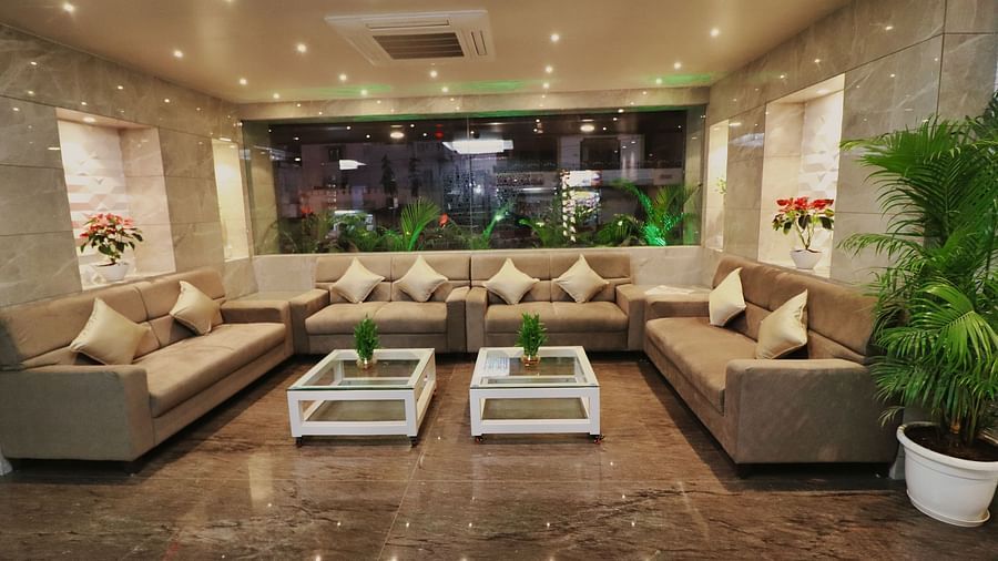 Image of the lobby at Clarks Inn Express, Udaipur with sofas and two tables in between.