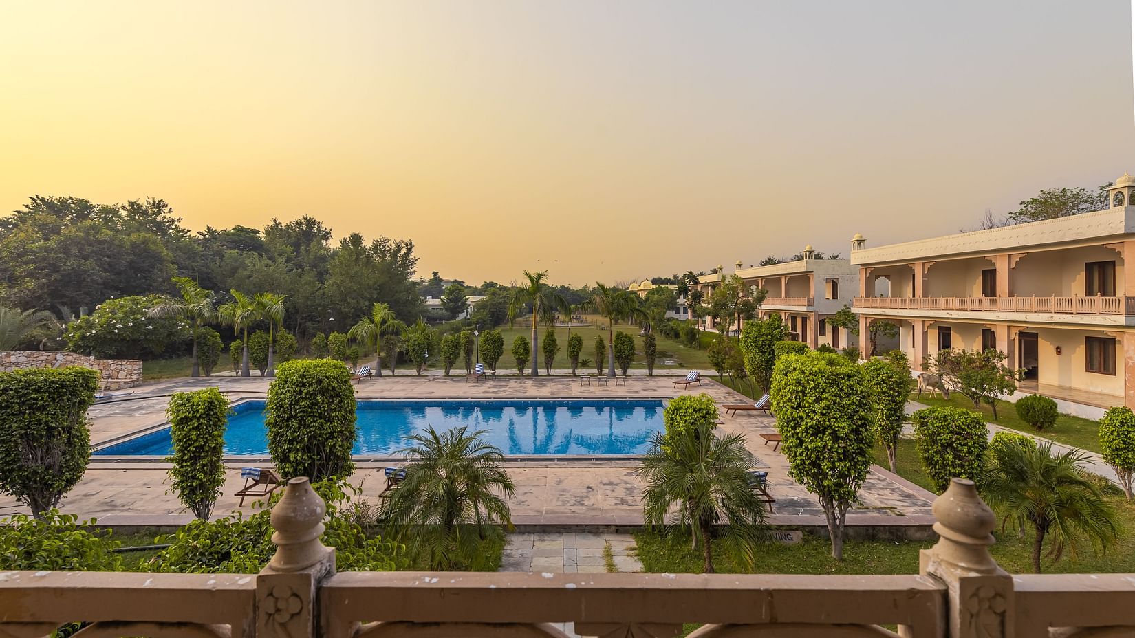 A view of the swimming pool and resort grounds at Clarks Inn Suites, Ranthambore.