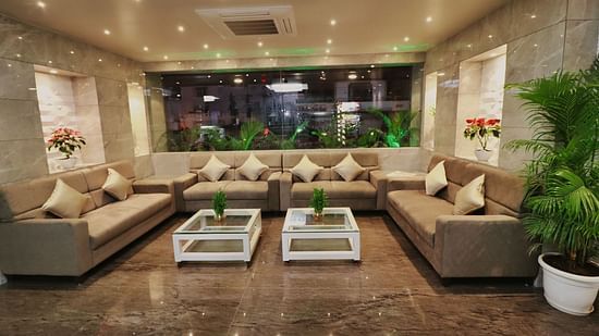Image of the lobby at Clarks Inn Express, Udaipur with sofas and two tables in between.