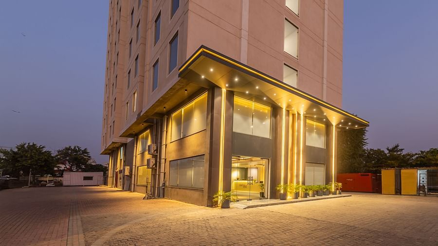 Facade of Clarks Inn Suites Jaipur, Ajmer Road featuring a well-lit entrance of the property during early evening