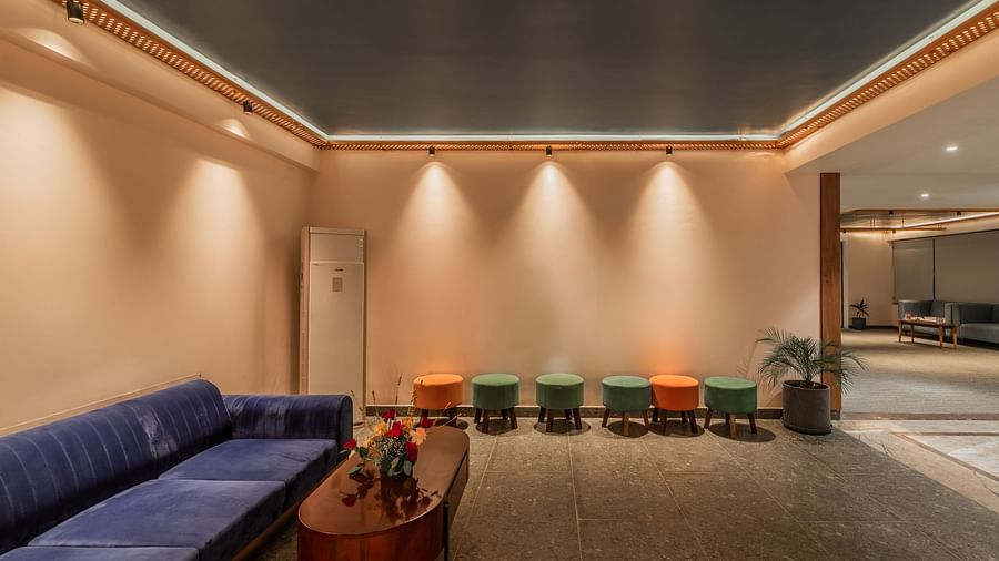 Lobby of Clarks Inn Suites Jaipur, Ajmer Road featuring multiple sitting spaces with colourful ottomans and a sofa with a coffee table