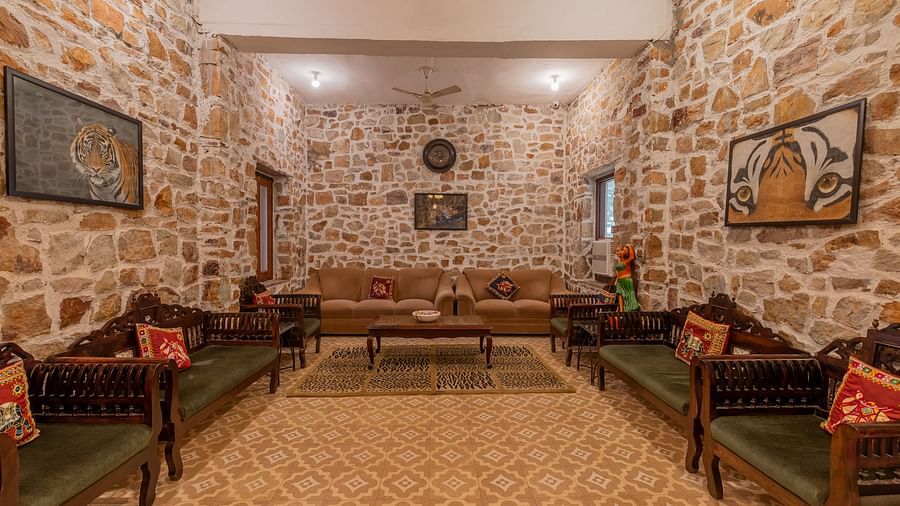 A lounge area at Clarks Inn Suites, Ranthambore, featuring comfortable seating and traditional decor.
