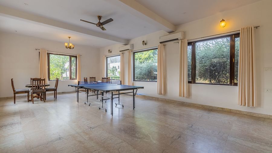 A common area at Clarks Inn Suites, Ranthambore with a table tennis table and seating for relaxation.