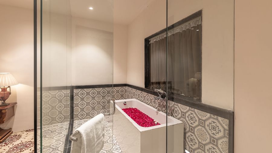 Luxurious bathroom with bathtub and glass enclosure at Clarks Resort The Archi's Castle, Ajmer.