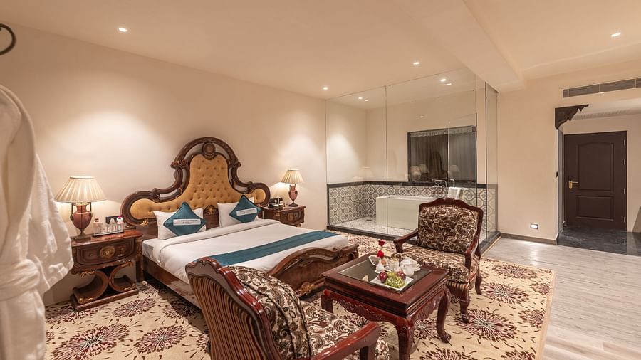 Heritage-inspired suite with carved furniture at Clarks Resort The Archi's Castle, Ajmer.