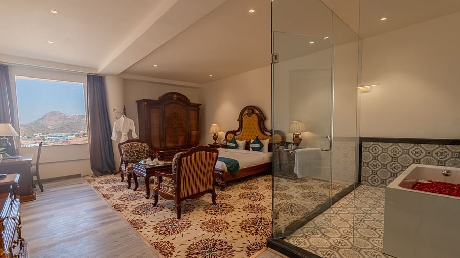 Elegant room with bathtub and seating area at Clarks Resort The Archi's Castle, Ajmer.