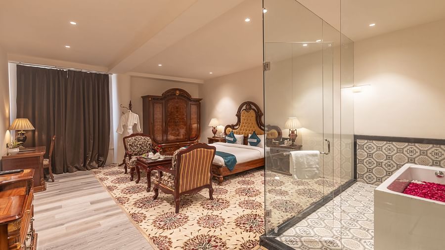 Premium suite featuring classic furniture and open bathroom at Clarks Resort The Archi's Castle, Ajmer.