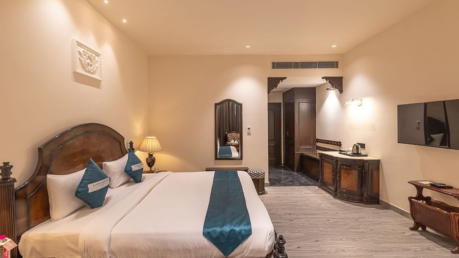 Well-appointed guest room with writing desk and TV at Clarks Resort The Archi's Castle, Ajmer.