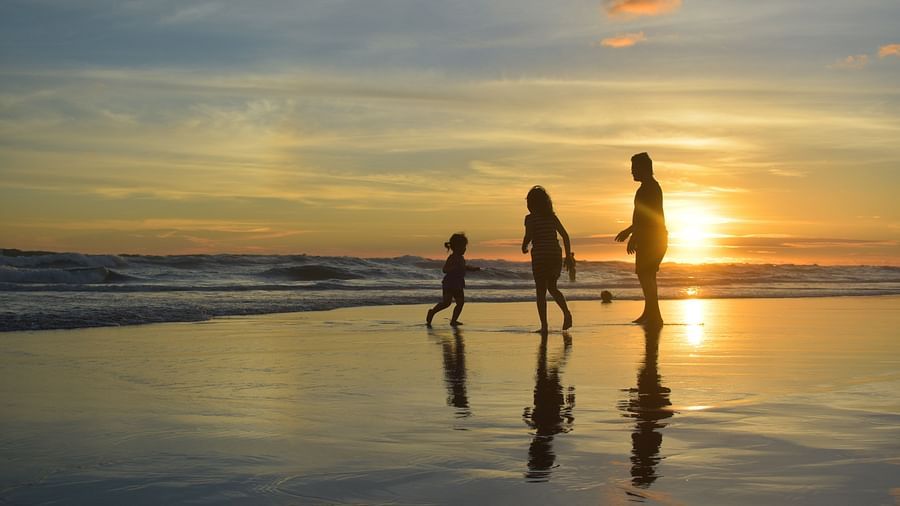 a family running and playing on the beach