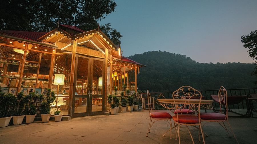 An outdoor patio with seating and a view of mountains.