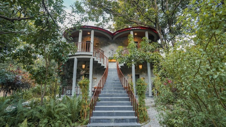 An exterior view of a building with trees and foliage in the background - The Den Corbett Resort & Spa, Kumeria.