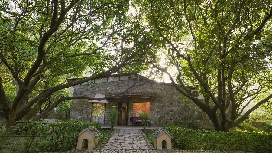 An exterior view of a building with a stone facade, surrounded by trees - The Den Corbett Resort & Spa, Kumeria.