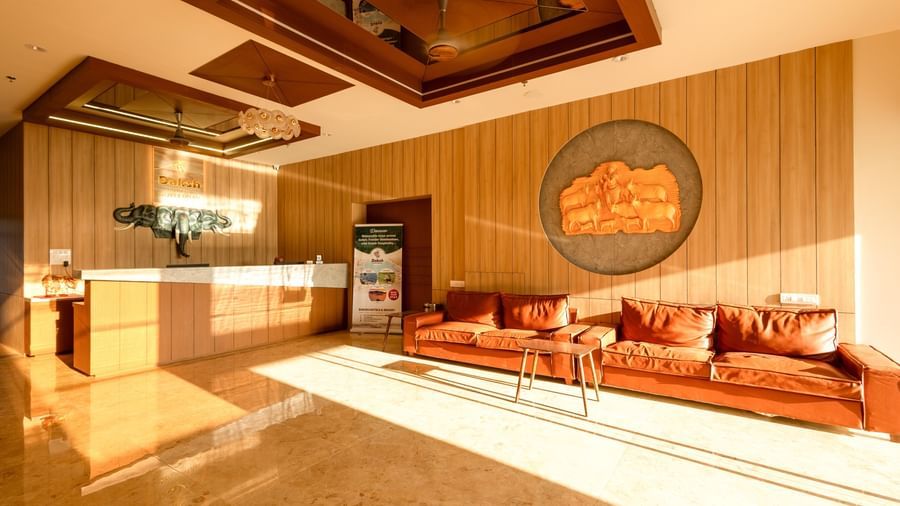 A wide-angle shot of the lobby area at Daksh The Grand Goverdhan, Dwarka, with bright natural light coming from outside.