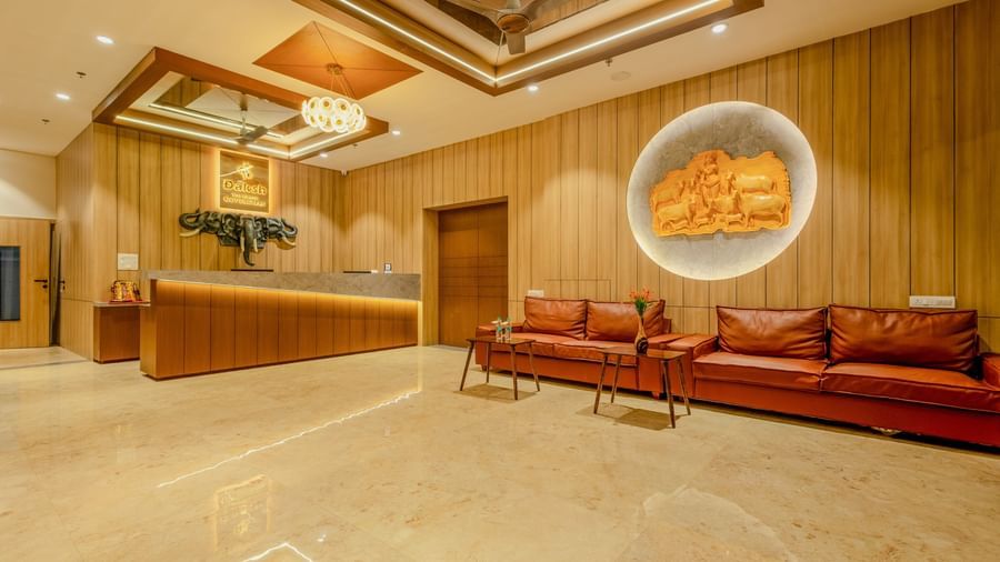 An expansive lobby area at Daksh The Grand Gowardhan, Dwarka, featuring a comfortable seating area along with a centre table in front of it.