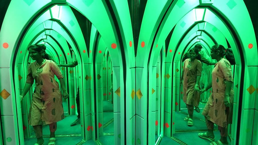 Mirror Maze at MGM Dizzee World featuring a woman trying to figure out her way out from the maze.