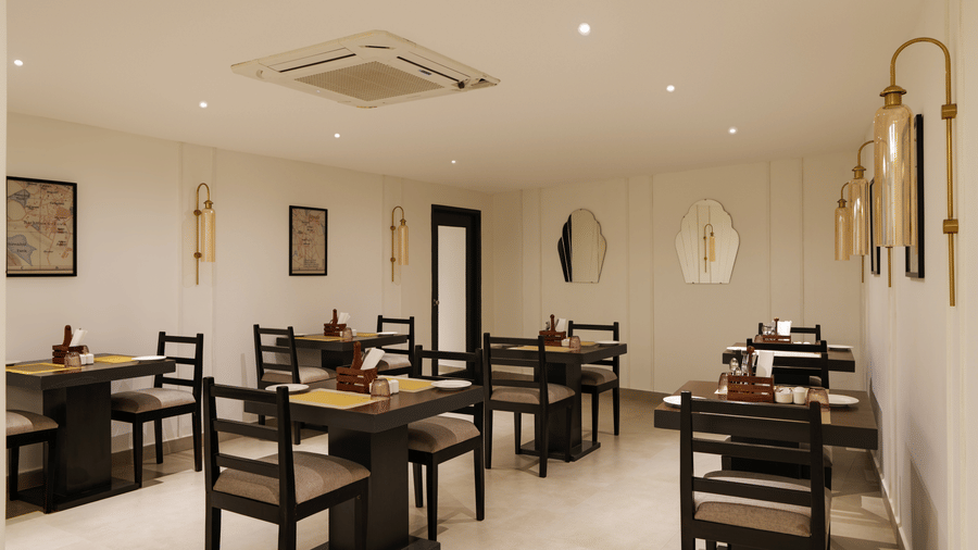 Restaurant at Shilton Suites, Bengaluru, with tables, chairs, and elegant interior furnishings.