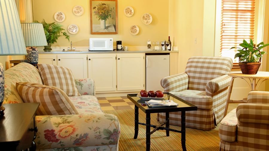 A cozy and inviting sitting area in a suite at the Tallman Hotel, featuring comfortable furniture and a kitchenette.