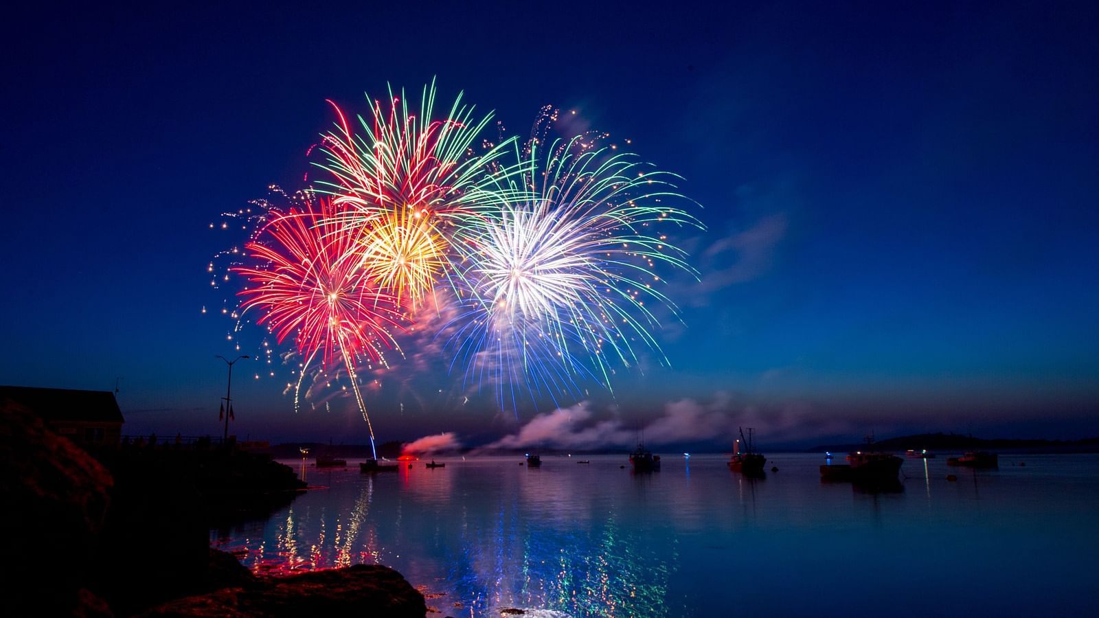 fireworks lighting up the night sky with different colours as seen from below