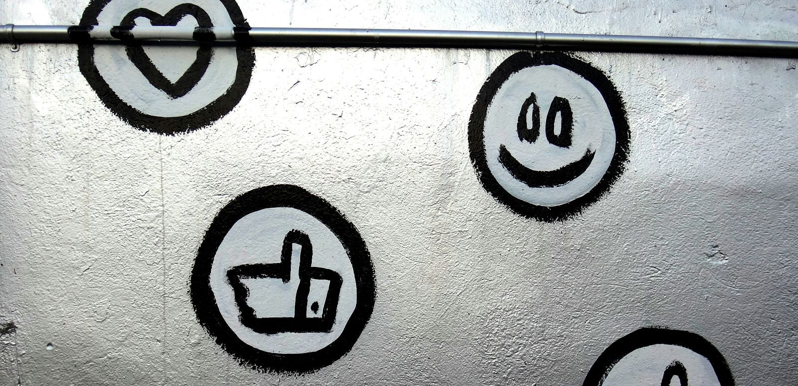 Wall art with icons like hearts, thumbs up, and smiley faces.