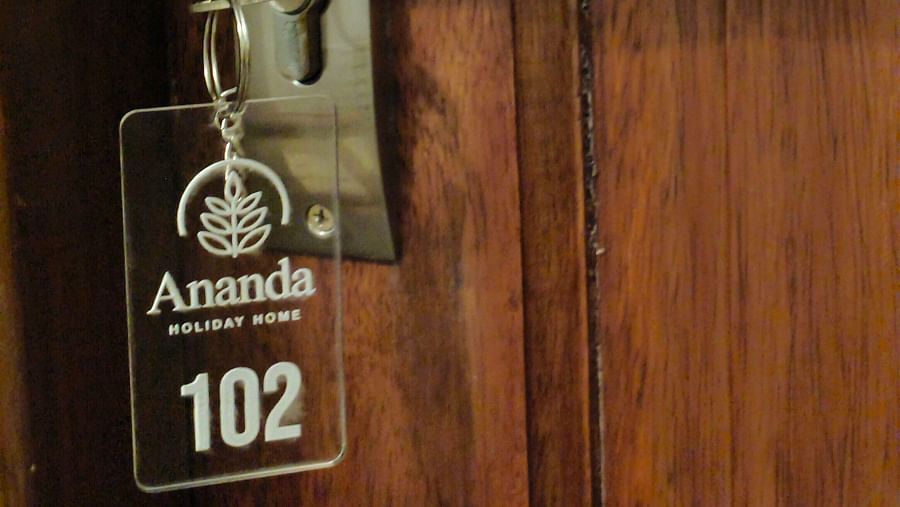 A Key with the key chain saying room 102 hanging on the door of 102 room at Ananda Holiday Home, Wayanad 1