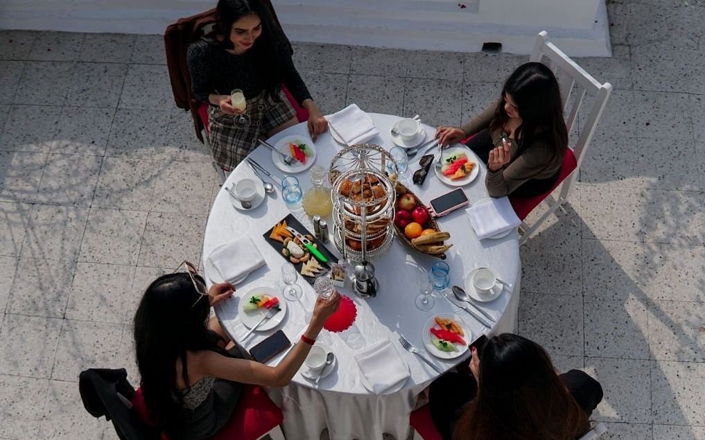 Aerial top view of a group of women sitting around a breakfast table