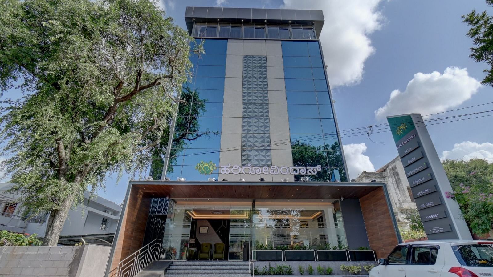 Facade of Hari Govindas, Siddappa Square with trees on the side.