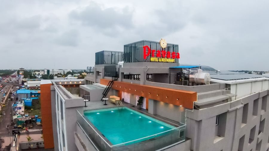 Rooftop swimming pool area of Pravasa Hotel with city views | Pravasa Hotel, Vijayapura