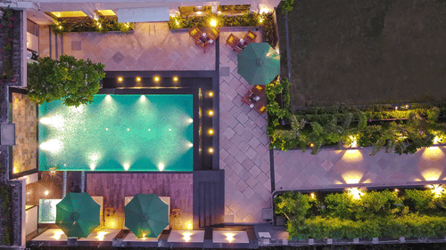 A swimming pool area well decorated with lights - Royale Sarovar Portico, Agra