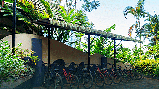A shed with cycles parked under it at Coorg Jungle Camp Backwater Resort, Kushalnagar.
