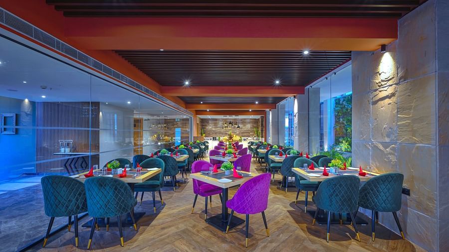 A restaurant featuring a variety of sofa chairs and tables - Royale Sarovar Portico, Agra