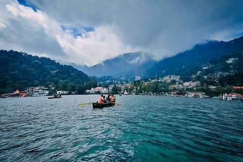 boat in a blue lake with mountains around it