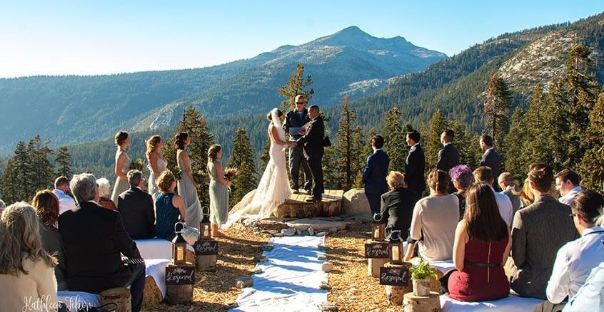 An outdoor wedding ceremony with a mountain backdrop, a memorable event near the Tallman Hotel.