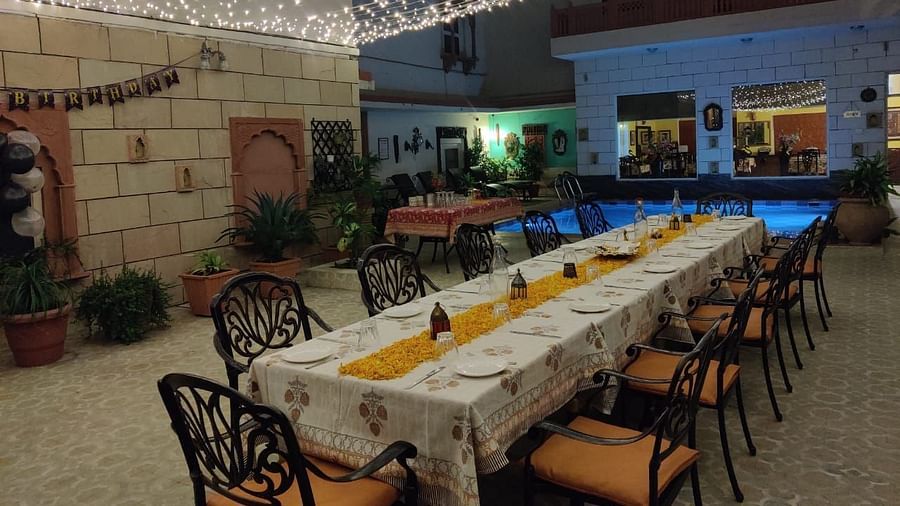 Seating arrangement with fairy lights on the top at Alfresco Dinner at the courtyard at Suryaa Villa Jaipur