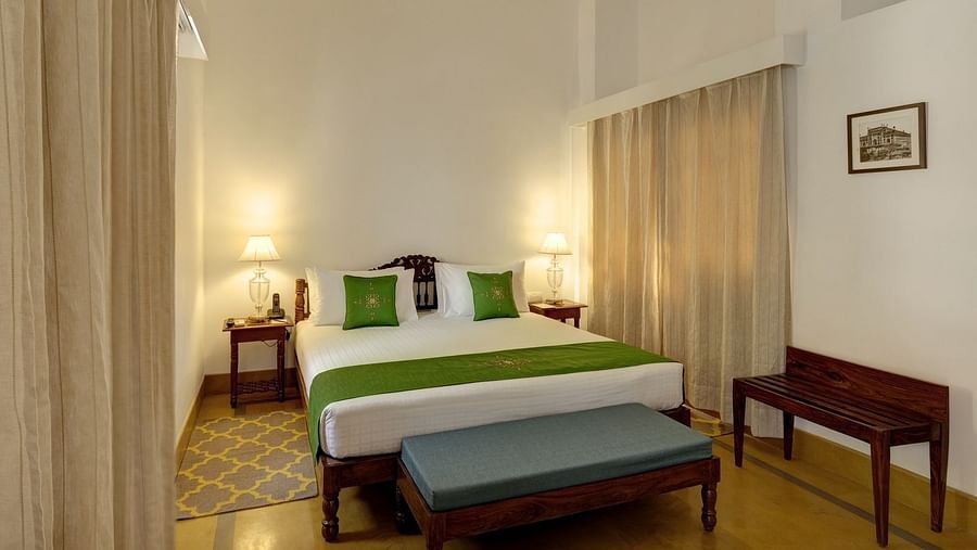 Residency Room at Saraca Hotel, Lucknow with a double bed and a chandelier