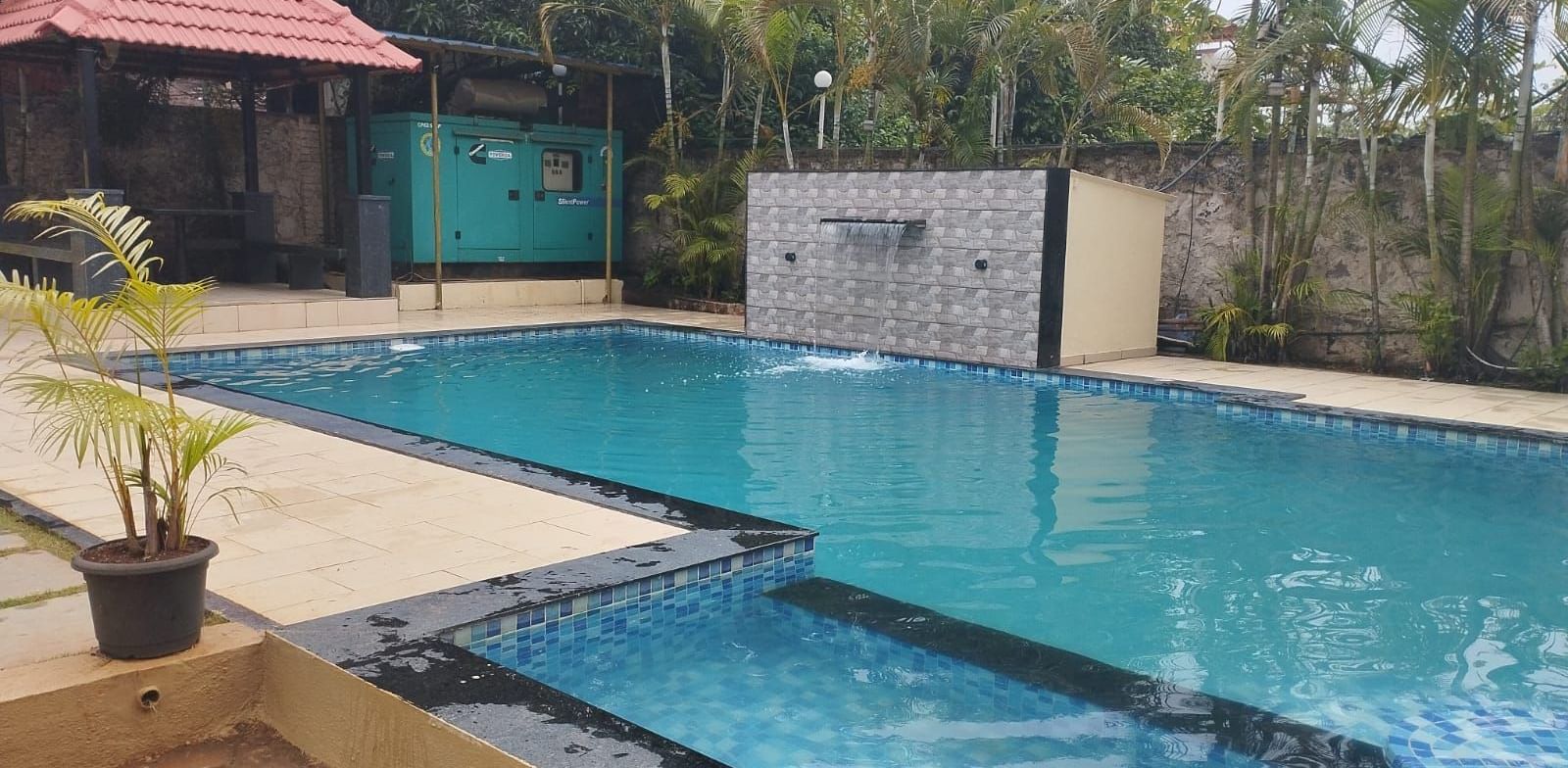 Outdoor pool area at Mountview Resort in Lonavala, featuring a gazebo by the side.