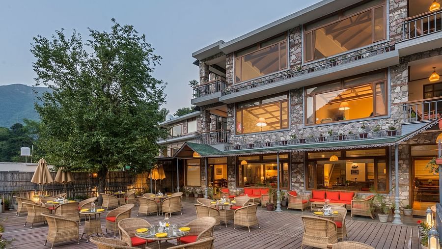 Outdoor restaurant at Fishermen's Lodge, Bhimtal, featuring a beautiful view, creating a perfect setting for dining in nature.