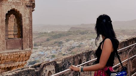 A woman looking out over the city of Jaisalmer from a balcony of Jaisalmer Fort in rajasthan
