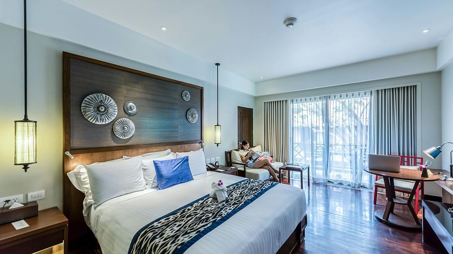 A bedroom featuring a stylishly decorated headboard with intricate patterns and soft lighting.