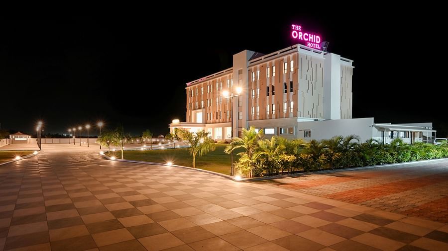 Facade image of The Orchid Hotel, Jamnagar in the night with the lights on 